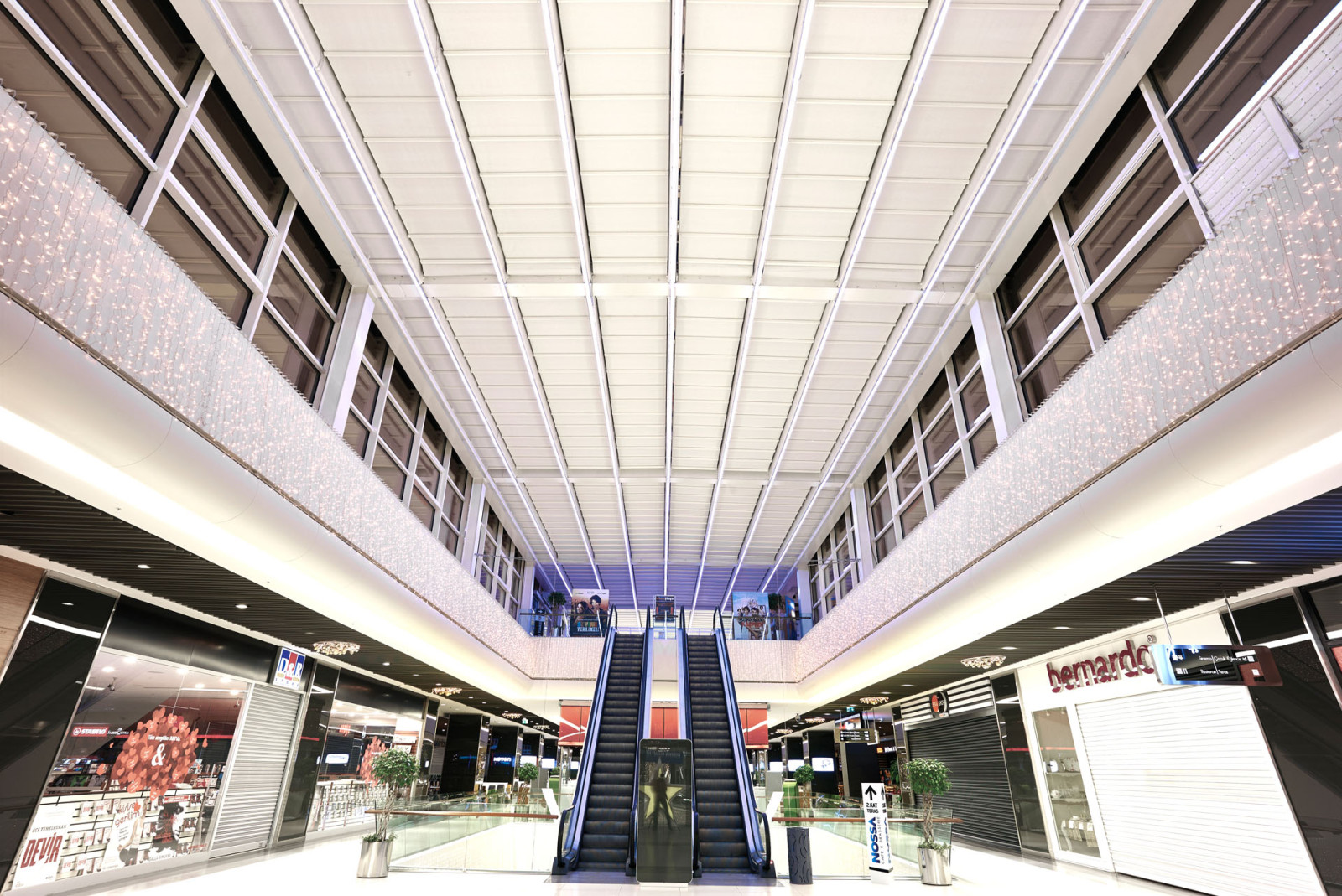 A spacious interior with a massive metal and tailor made fabric pergola roof.