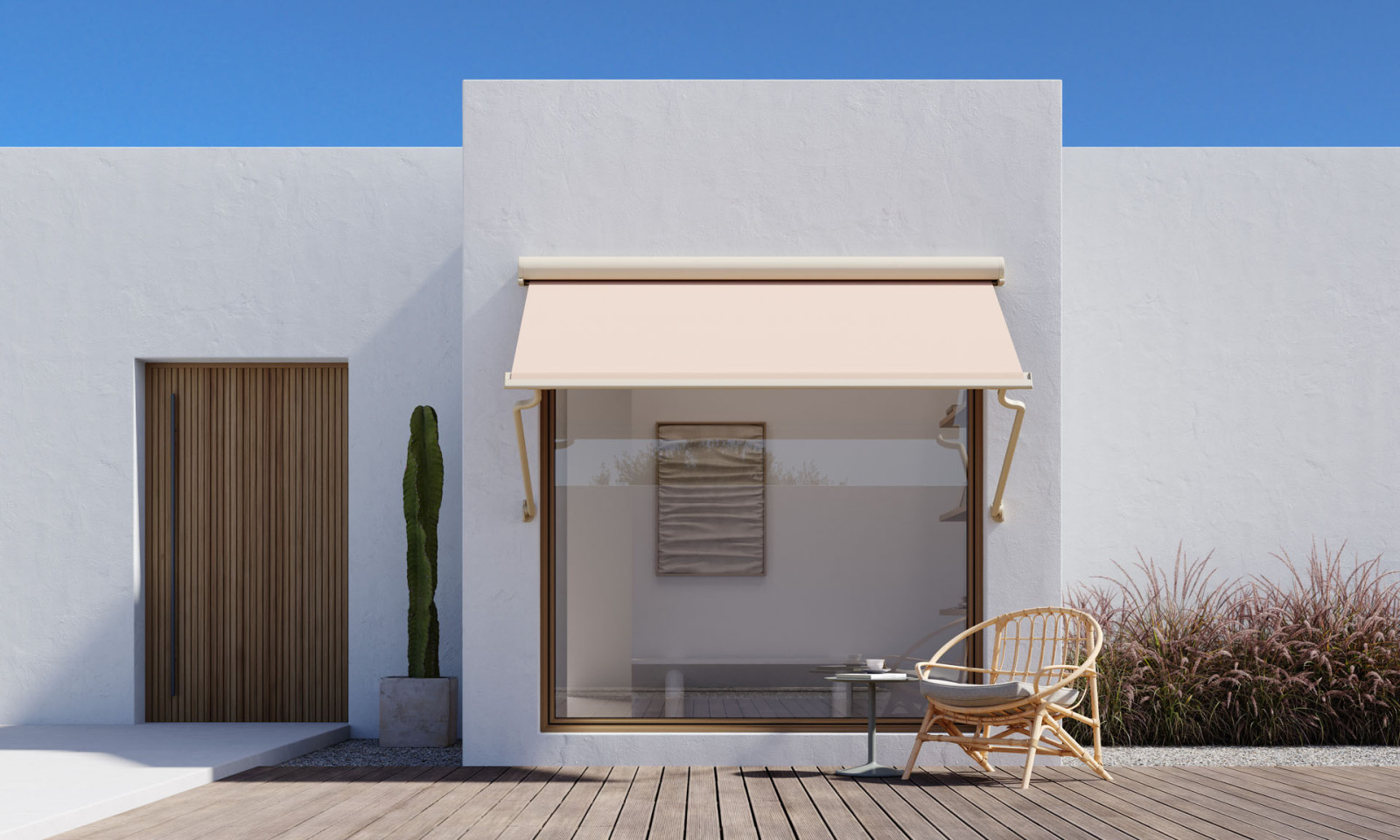 White house with wooden deck, modern looking awning and and patio, surrounded by greenery.