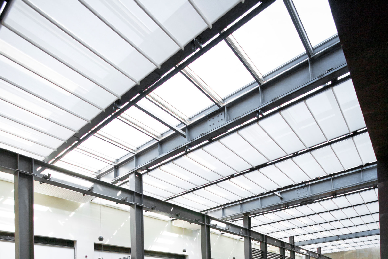 A spacious interior with a massive metal and tailor made fabric pergola roof.
