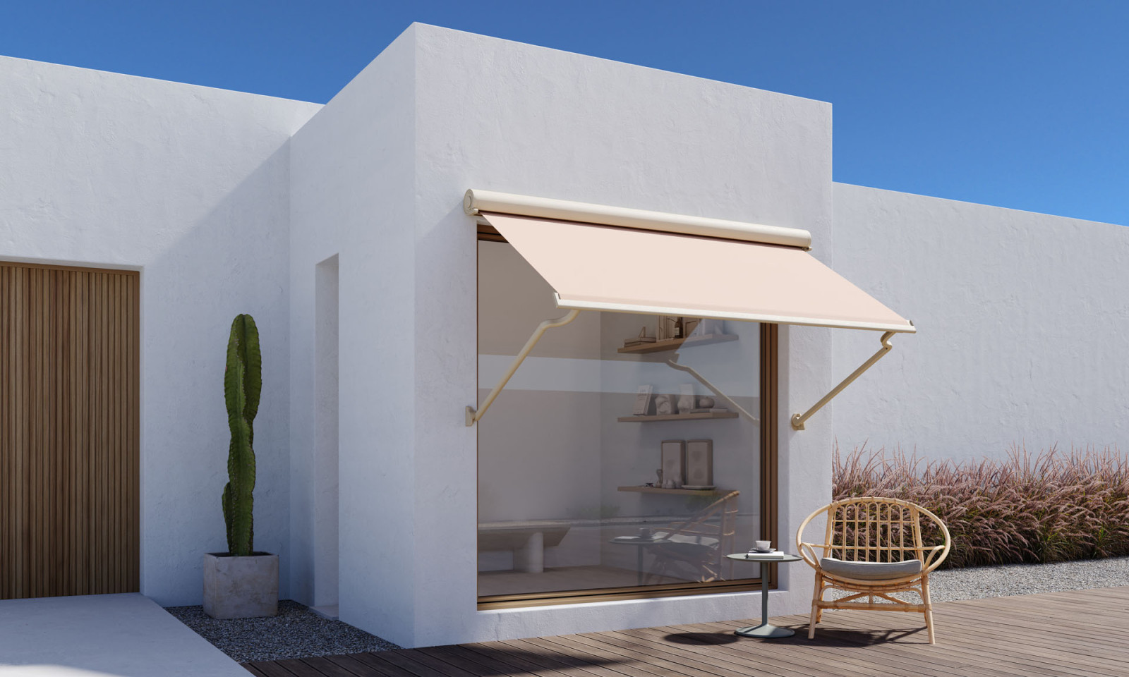 White house with wooden deck, modern looking awning and and patio, surrounded by greenery.