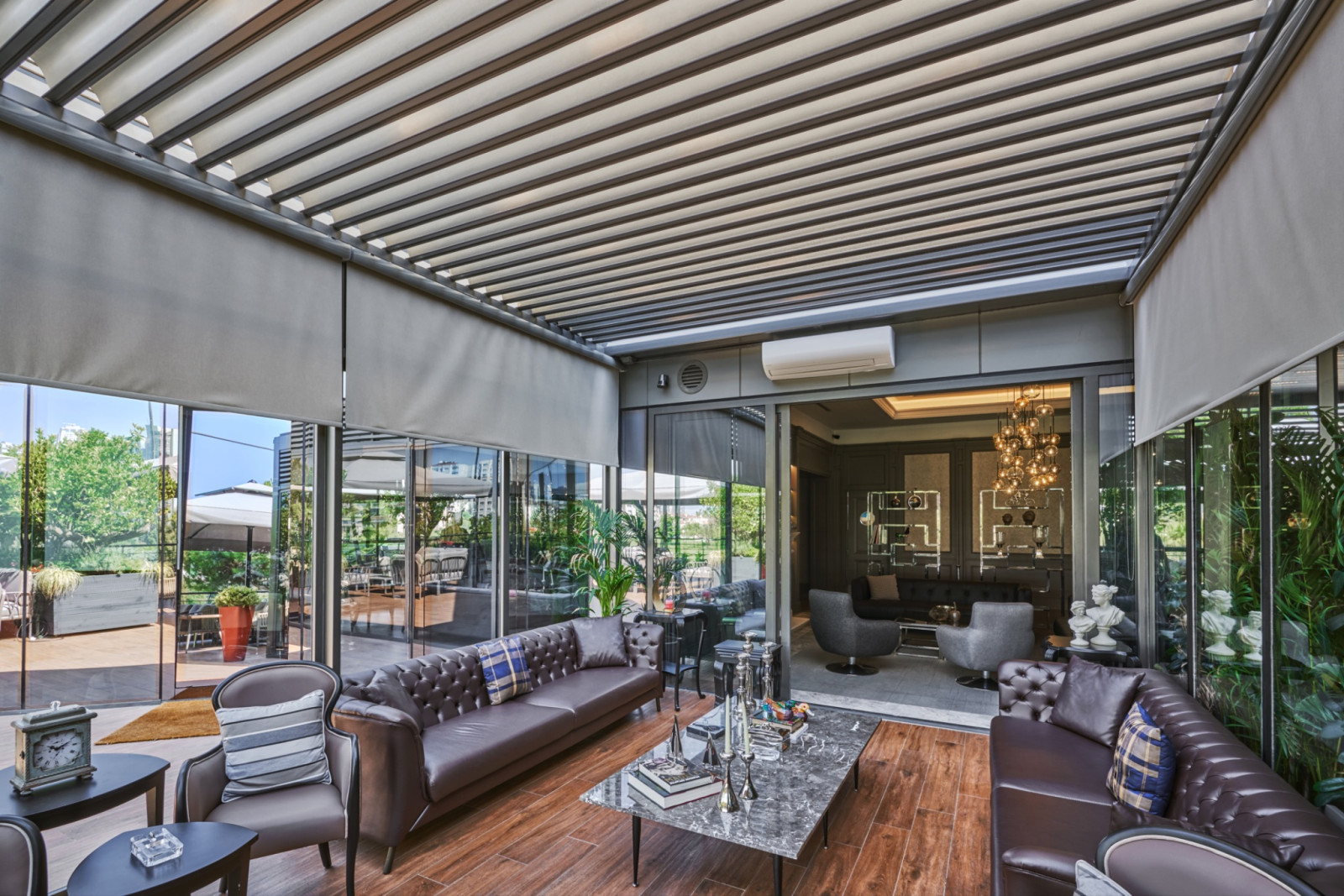 A living room featuring a glass ceiling that allows natural light to illuminate the wooden floors beneath.