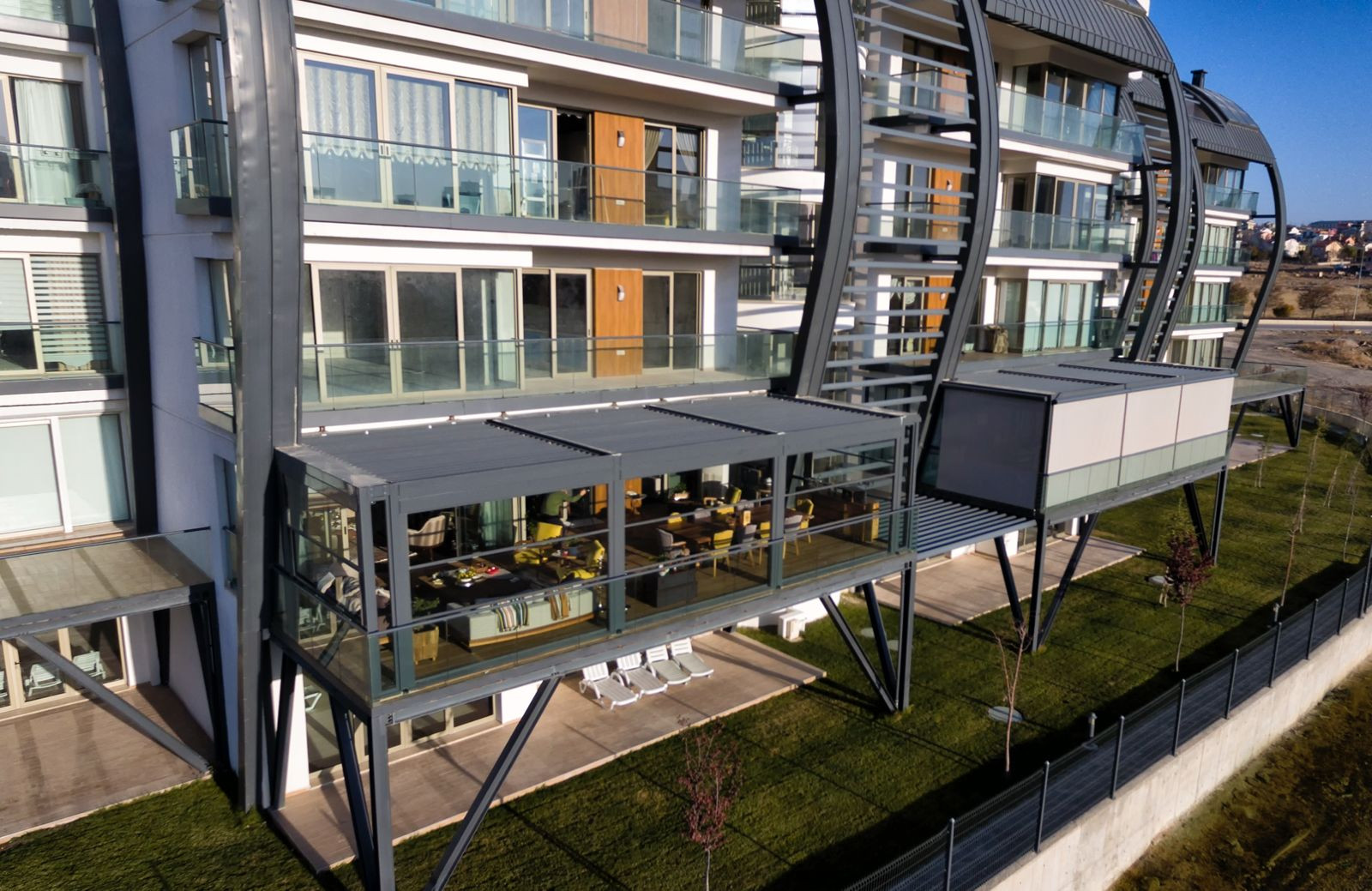 Contemporary apartment building with balconies, showcasing the Beytepe Restorium Pergola project by Palmiye.